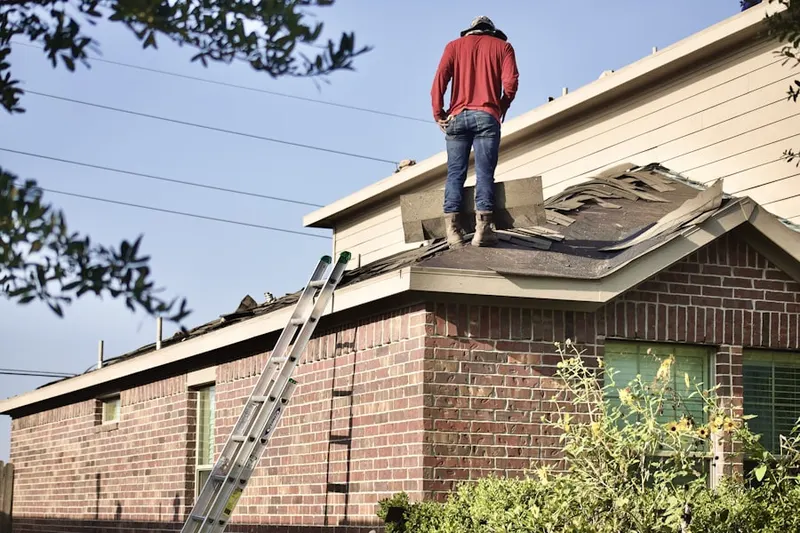 Professional roofer working on a residential roof in Oreville